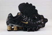 Nike Shox TL Sneakers in Black and Gold